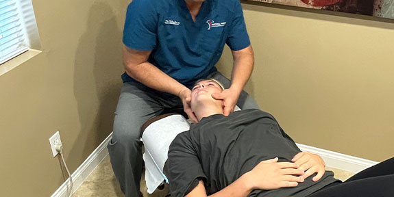 patient getting diversified chiropractic in Ontario for auto accident injury