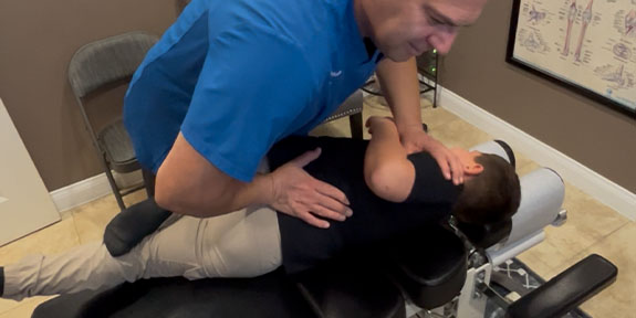patient getting drop table chiropractic in Ontario for auto accident injury